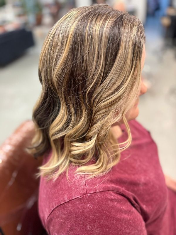 Soft blonde balayage with loose curls